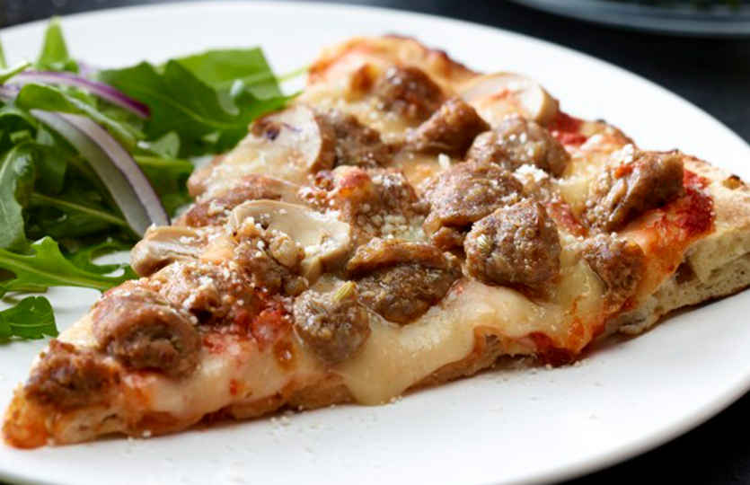 Sausage pizza slice on plate