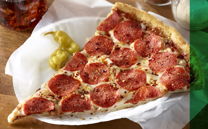 Slice of pepperoni pizza on paper plate